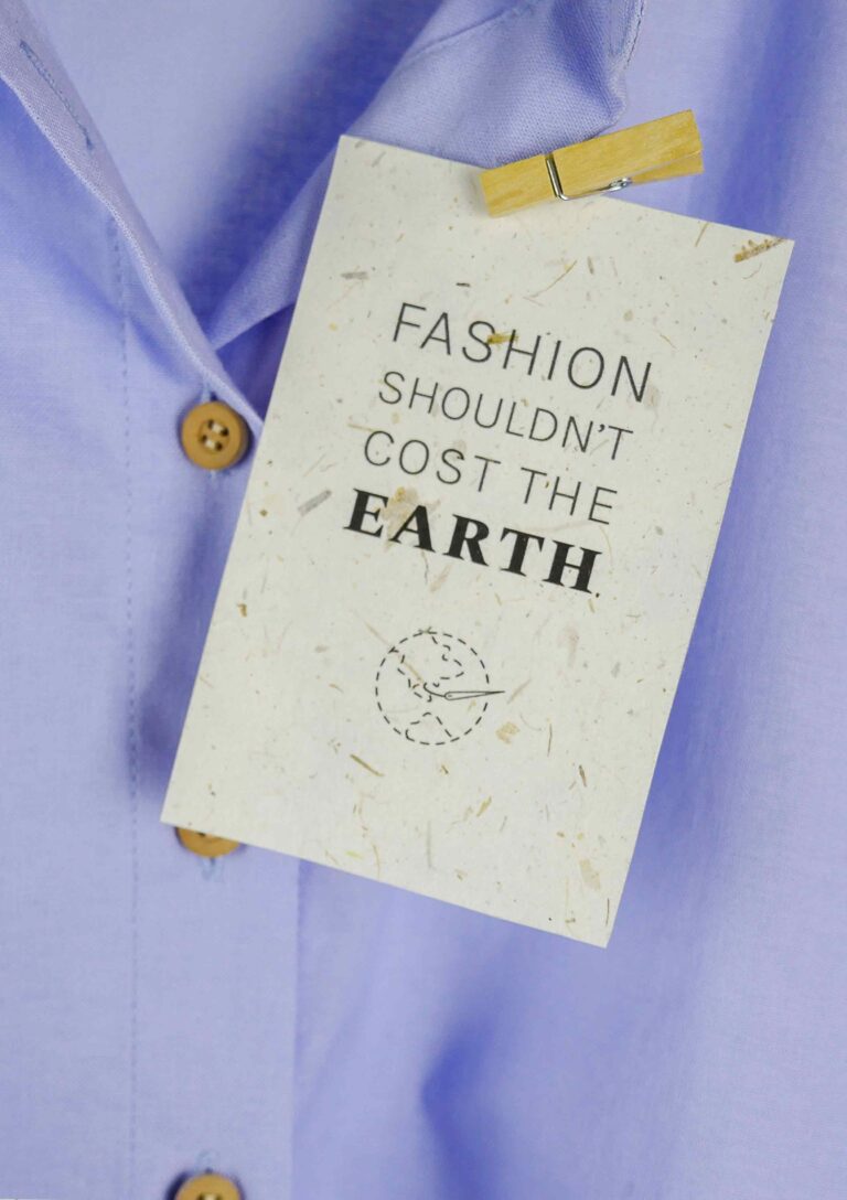recycled paper card saying that fashion should not cost the earth