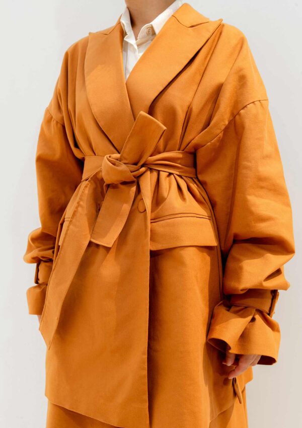 orange blazer with waist belt made from sustainable materials