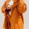 Woman wearing orange cotton blazer made from sustainable materials