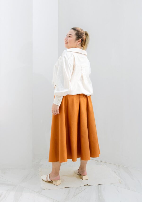 plus size woman wearing orange skirt made from eco materials