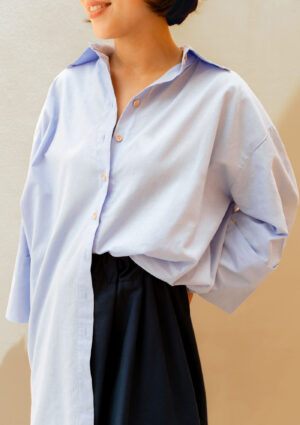 woman with light blue cotton shirt