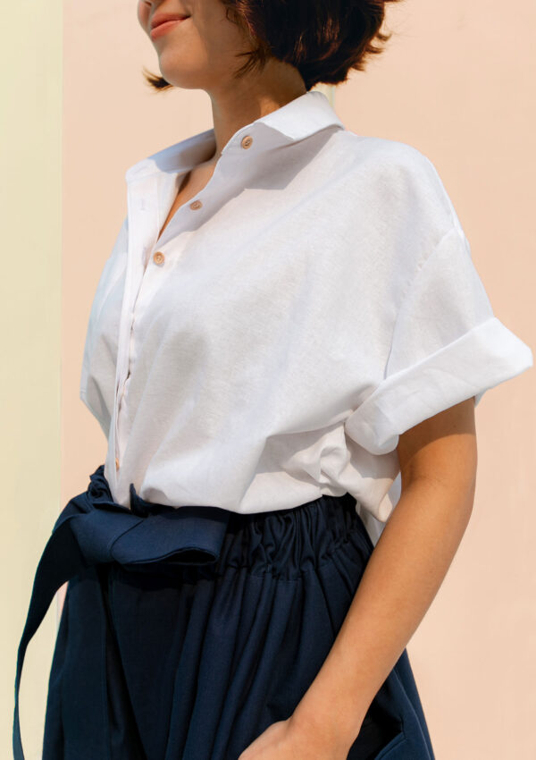 Woman wearing white cotton shirt made from organic and recycled cotton