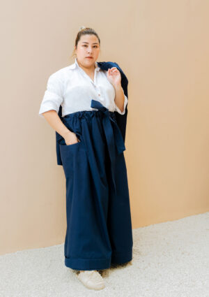 woman wearing oversized dark blue trousers made from organic and recycled cotton