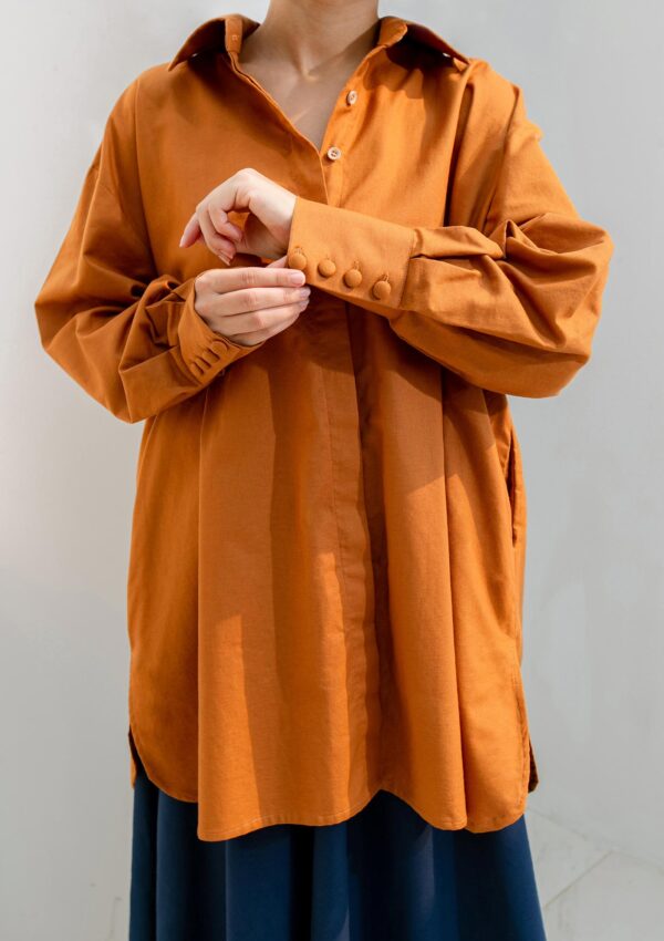 woman wearing long orange cotton shirt