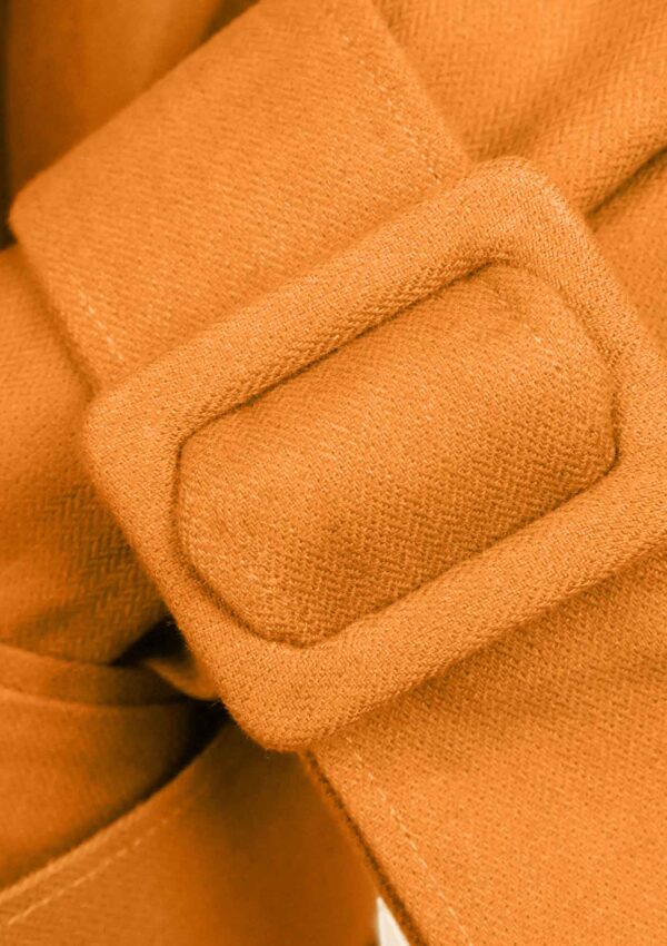 Detail of orange cotton blazer made from sustainable materials