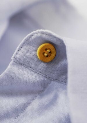 Button on light blue cotton shirt